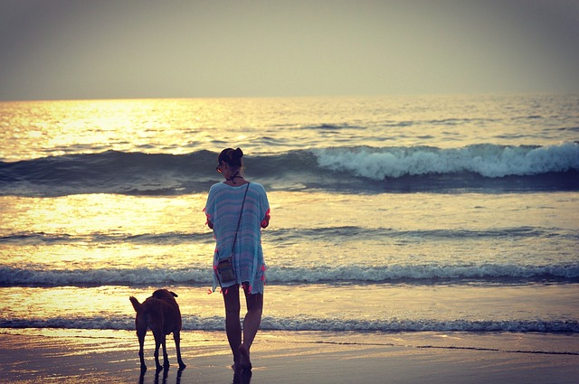 a women walk with dog on a goa bitchj
